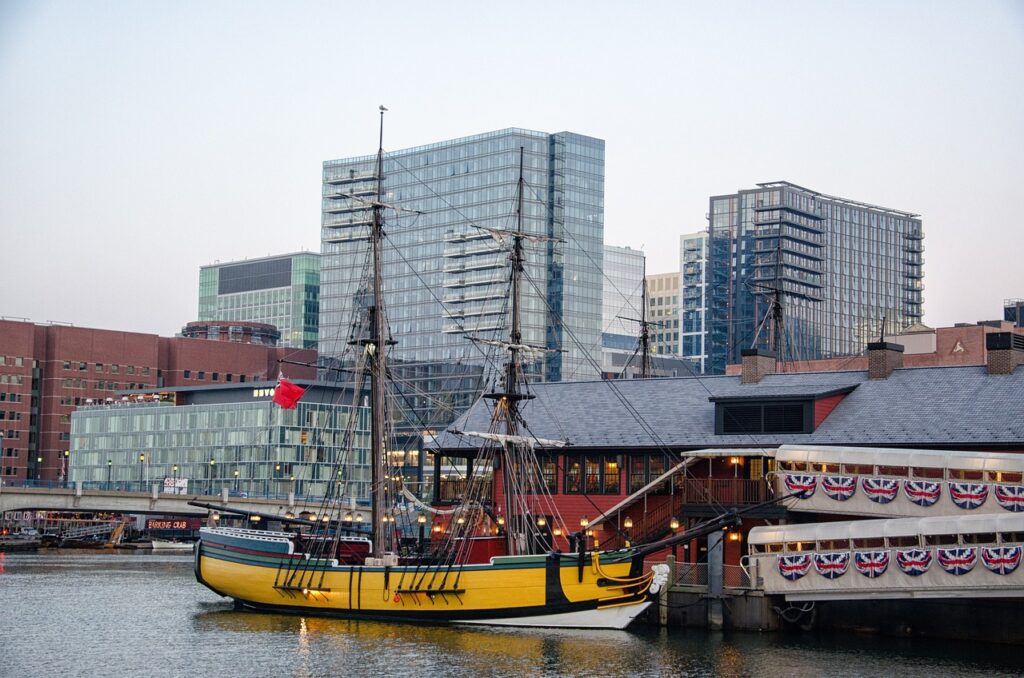 Yellow historical boat floats outside the Boston Tea Party Museum.