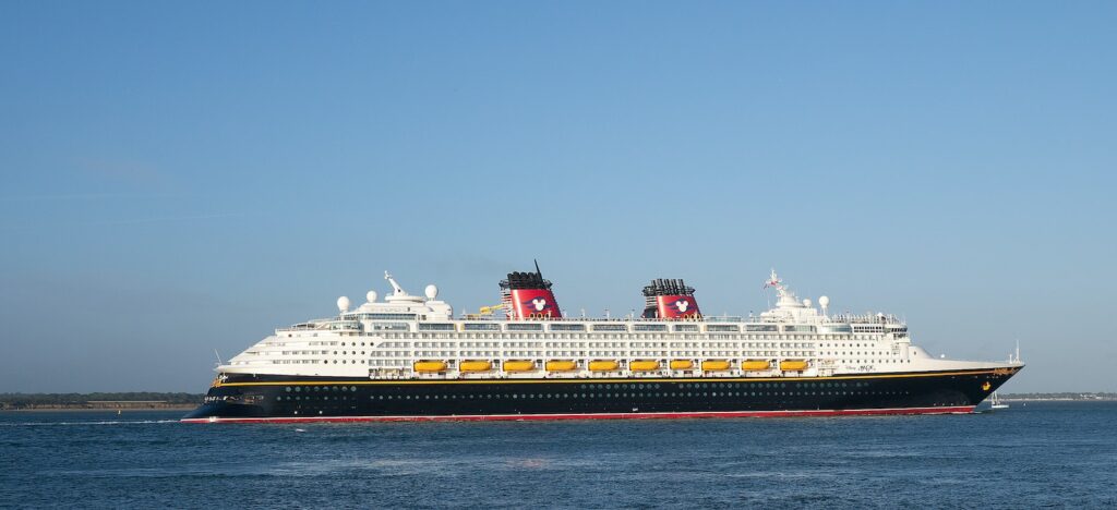 Black and white cruise ship with red stacks on the water during daytime 