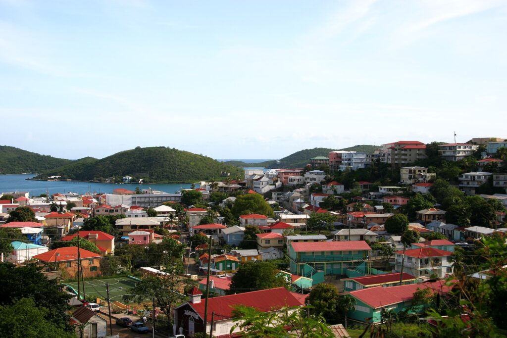 Areal view of red-roofed house by a bay