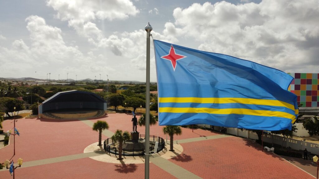 Aruban flag flies in a town square