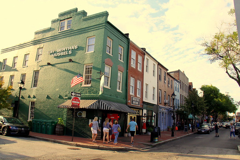 Fells point in Baltimore displaying some local restaurants and people walking 
