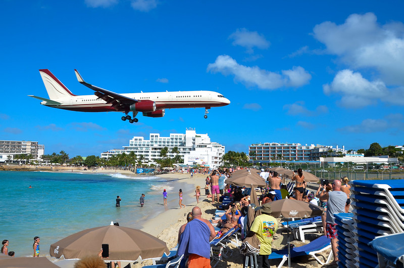 Crowd gathered watching a plane flying over Maho Beach in St. Maarten.