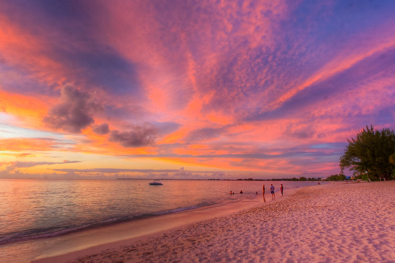 People enjoying the sunset at the seven mile beach in Grand Cayman