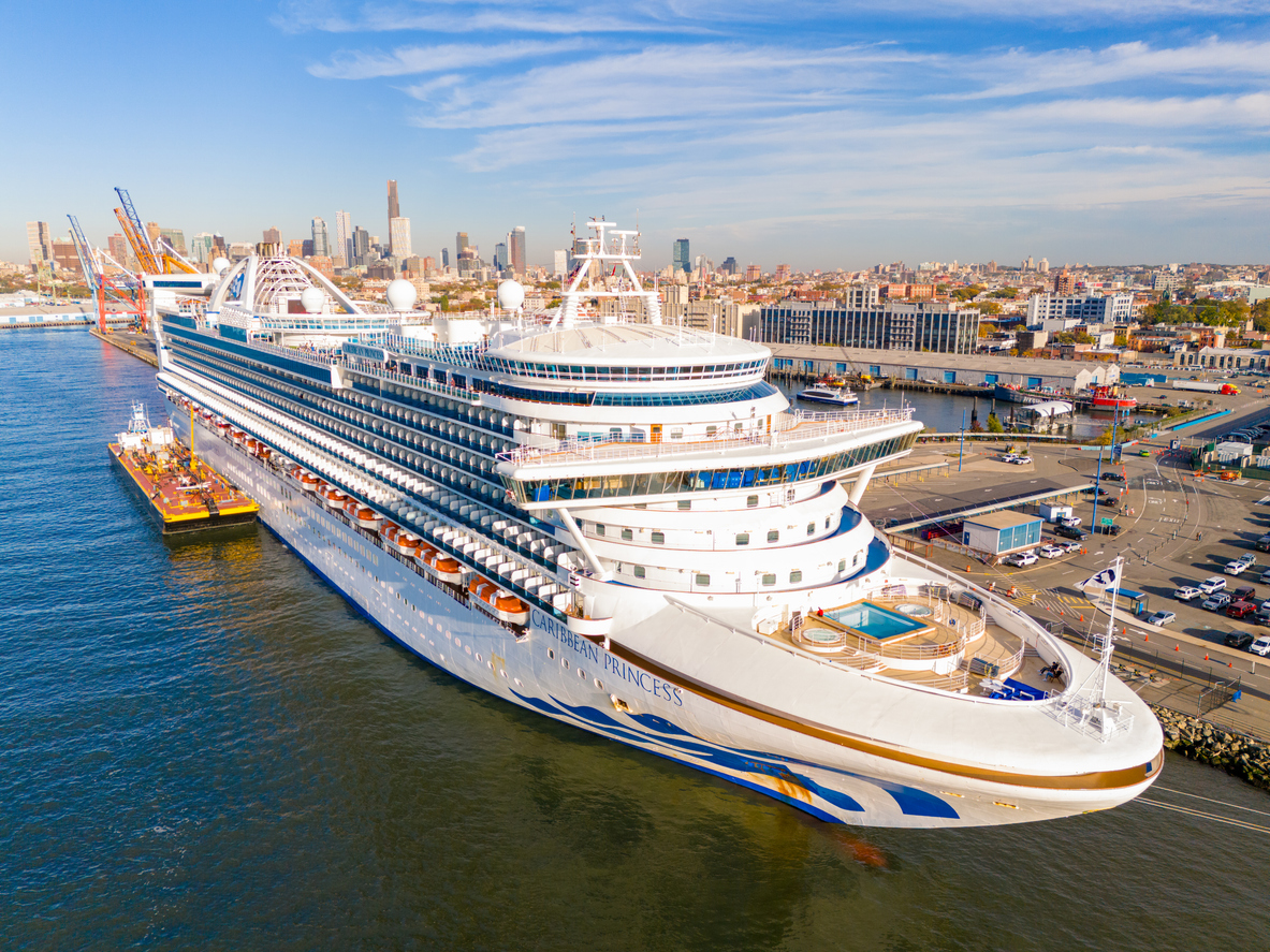 Cruise ship arrives to the port in New York, New York. View of the city in the background