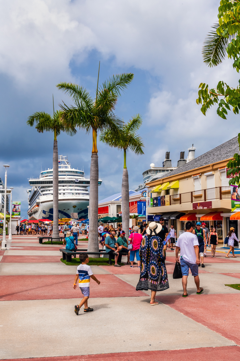 A colorful view of a tourist area with cruise ship in the background in Phillipsburg, St. Maarten