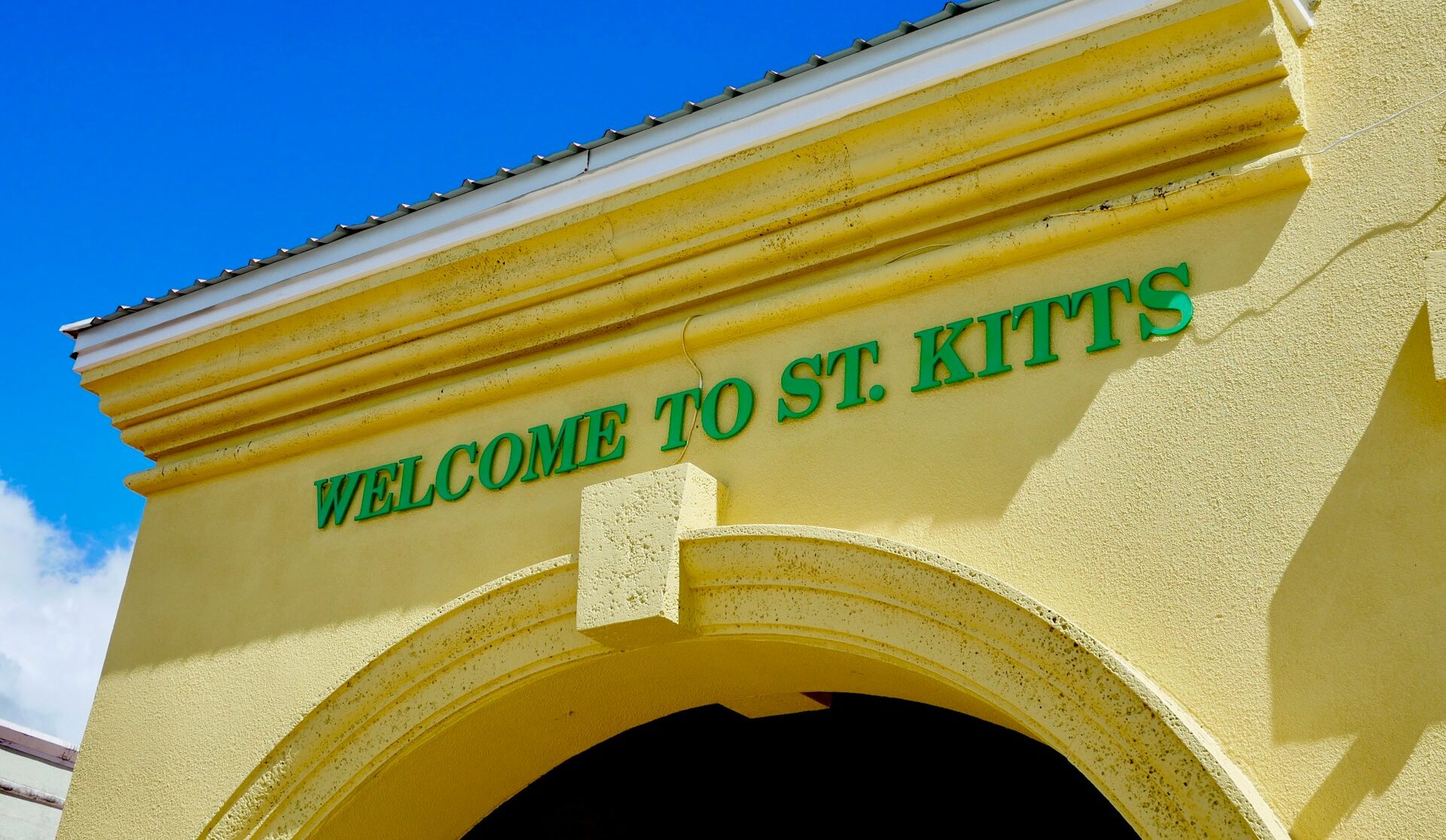 Sign on building that states "Welcome to St. Kitts"