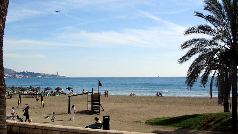people enjoying the beach with a great view of the ocean in Malaga, Spain