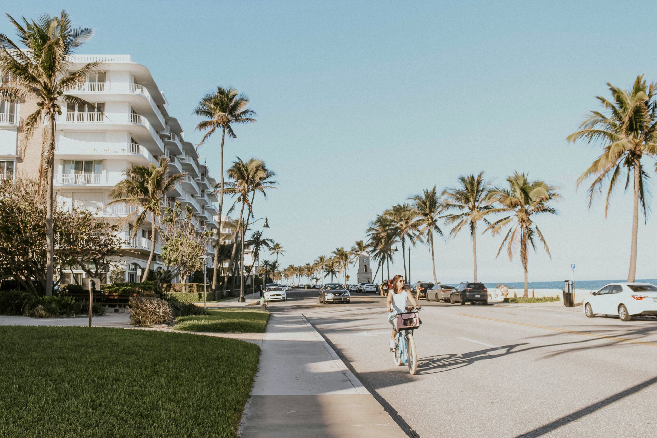 woman riding bike on the street at the beach in Palm Beach, Florida