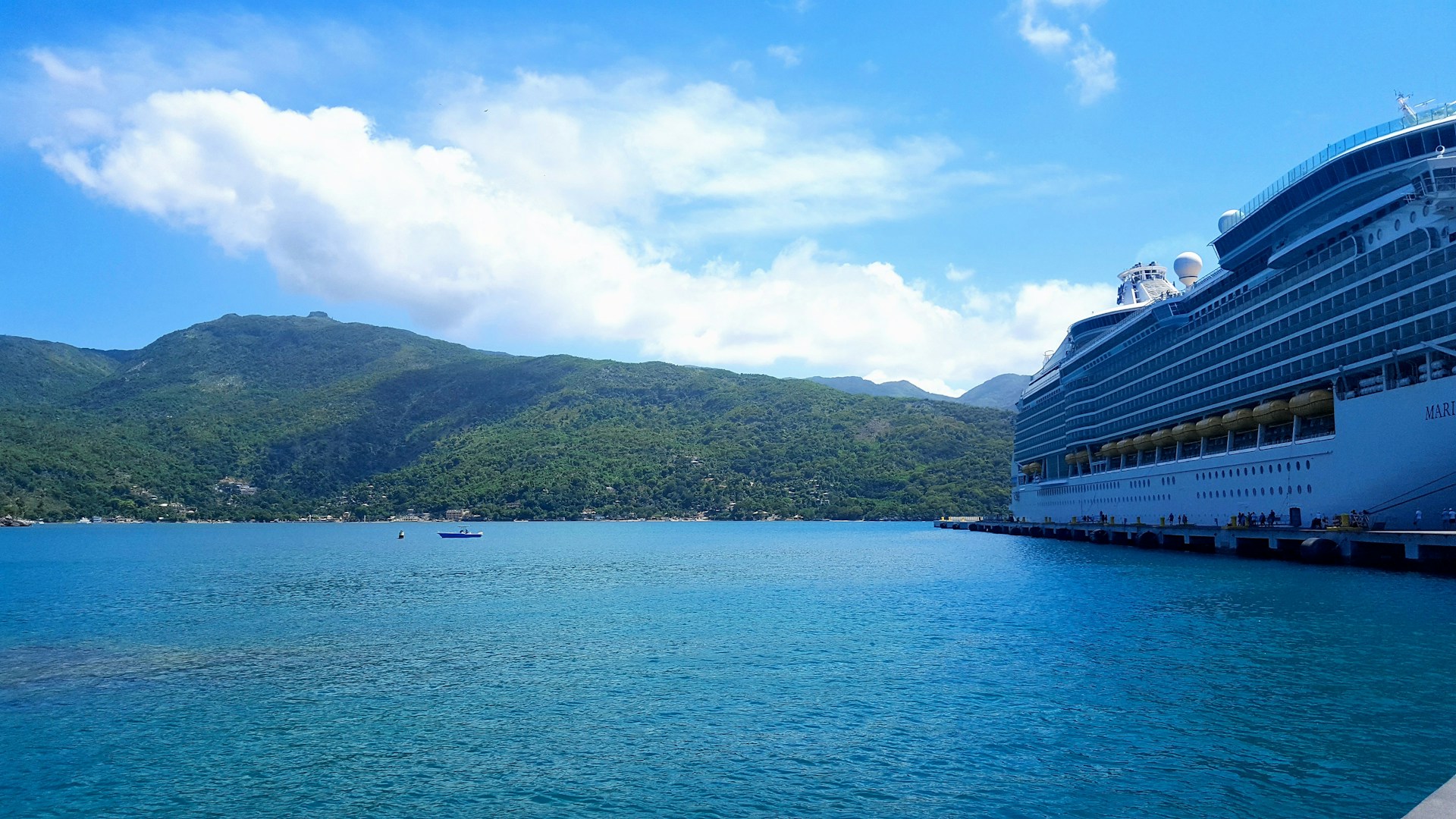 Cruise ship arriving at the port in Labadee, Haiti. Beautiful water and mountains in the background.