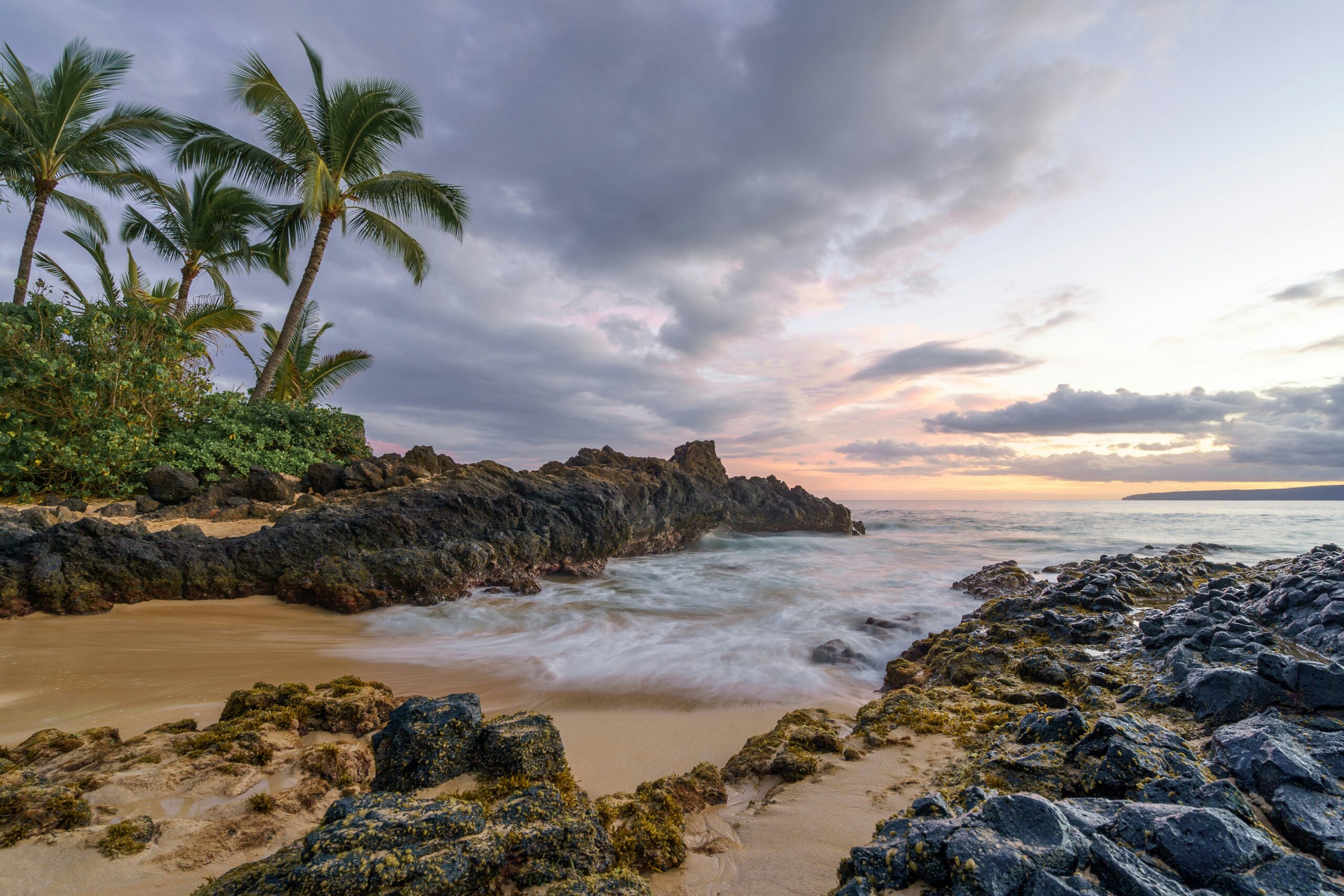 The beach with a view of the sunset in the background in Maui, HI