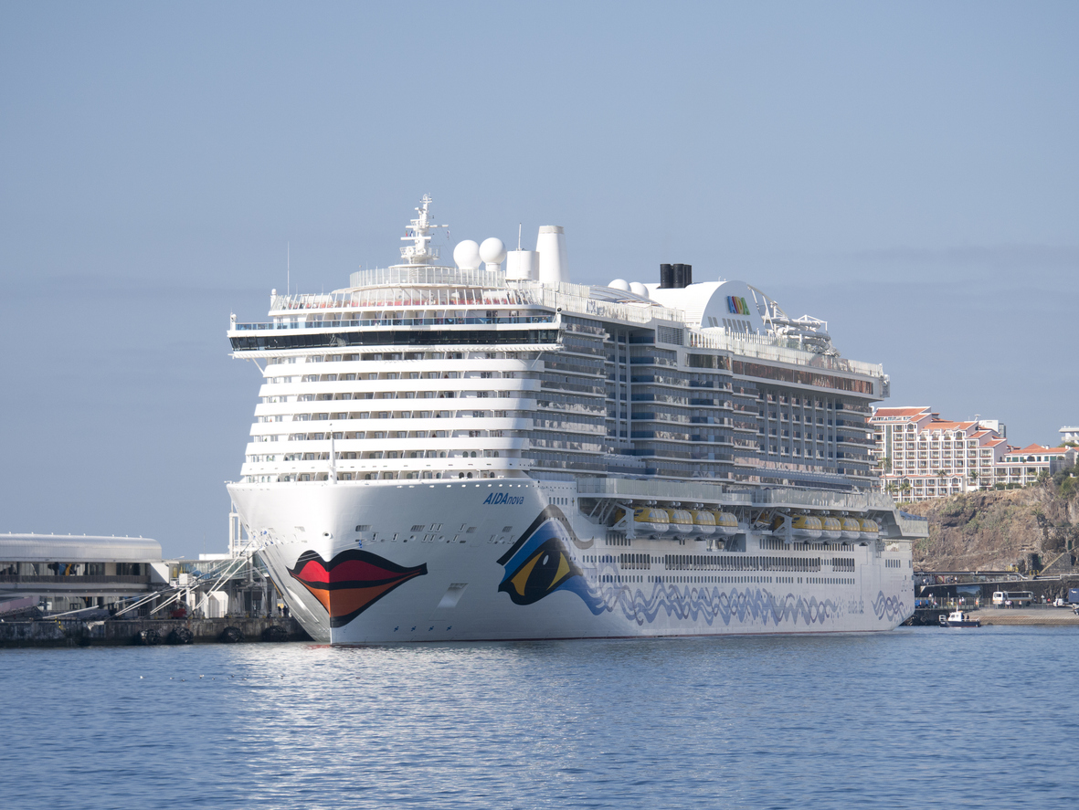 
The AIDA Nova cruise ship in Funchal Harbour against a blue sky and a blue sea.
